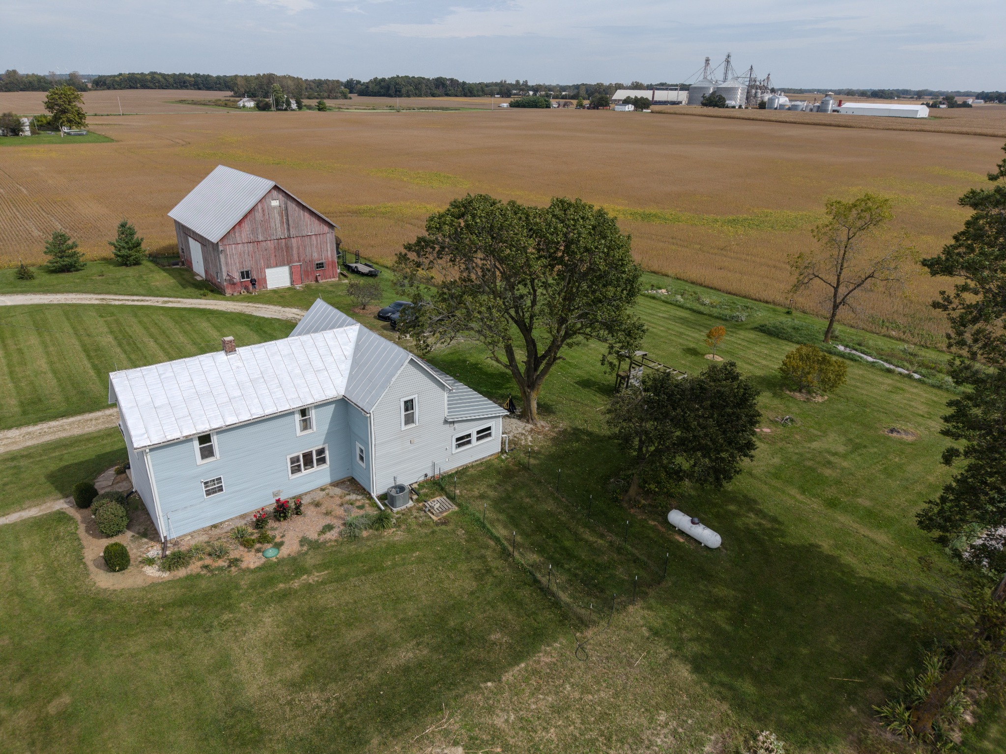 Aerial photograph showing a rural home, barn and surrounding farmland